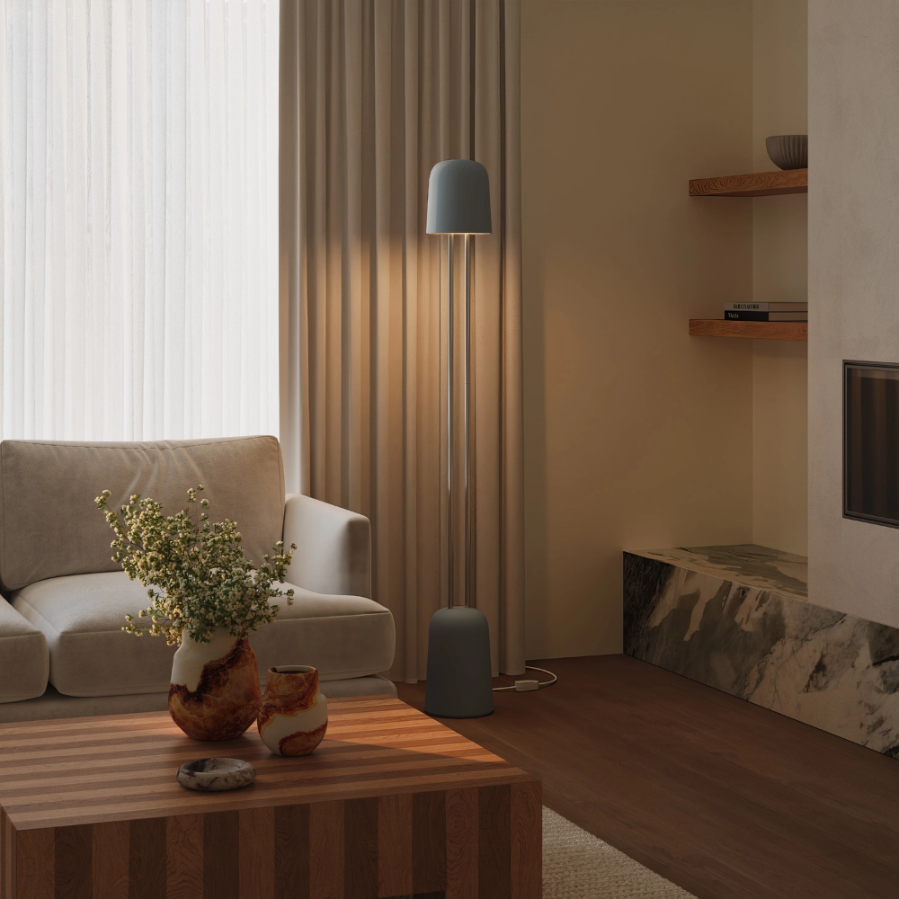 The fog Gio Floor Light from Gantri with the chrome rod option in a family space beside a sofa.