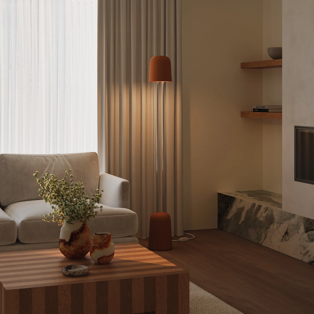 The sedona Gio Floor Light from Gantri with the chrome rod option in a family space beside a sofa.