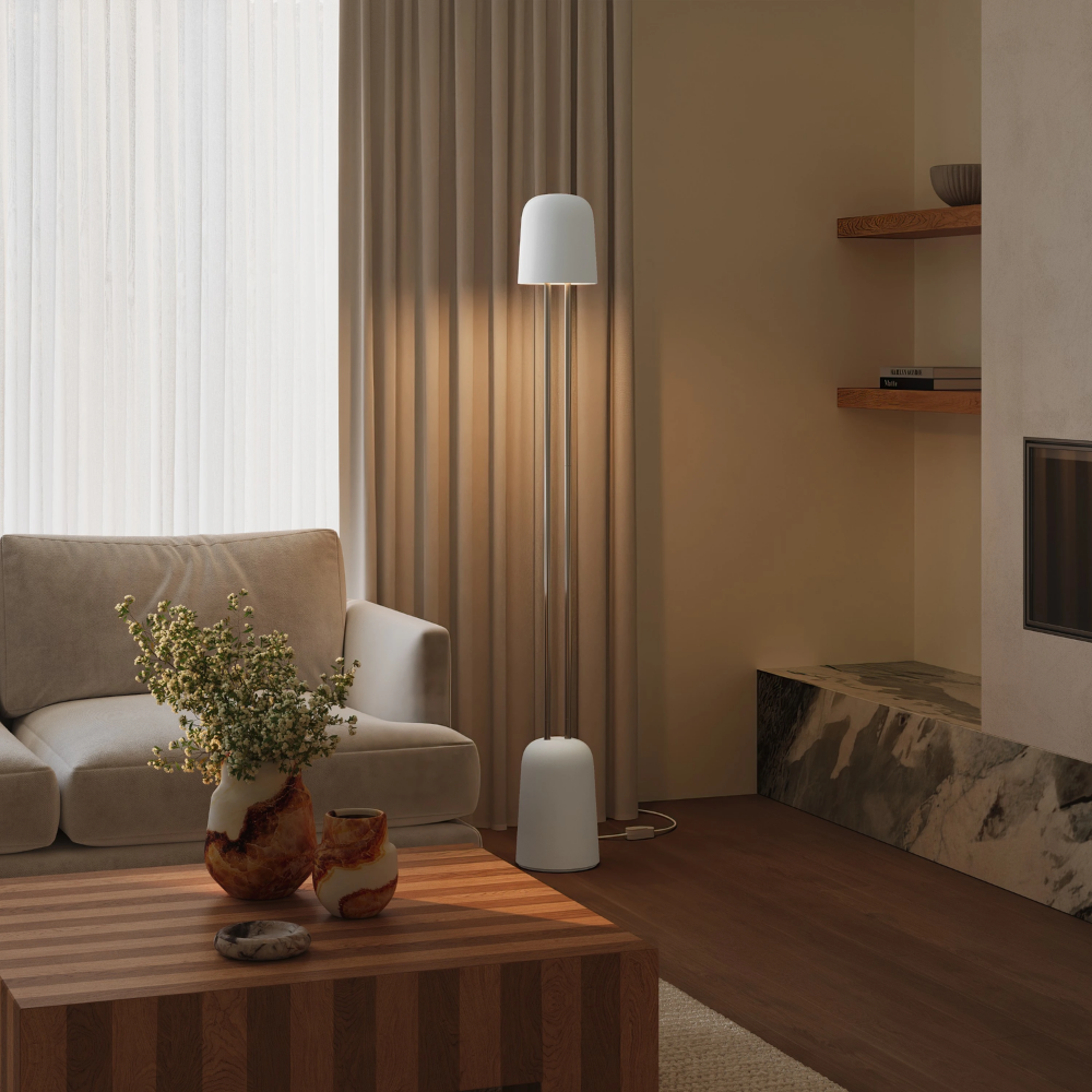 The snow Gio Floor Light from Gantri with the chrome rod option in a family space beside a sofa.