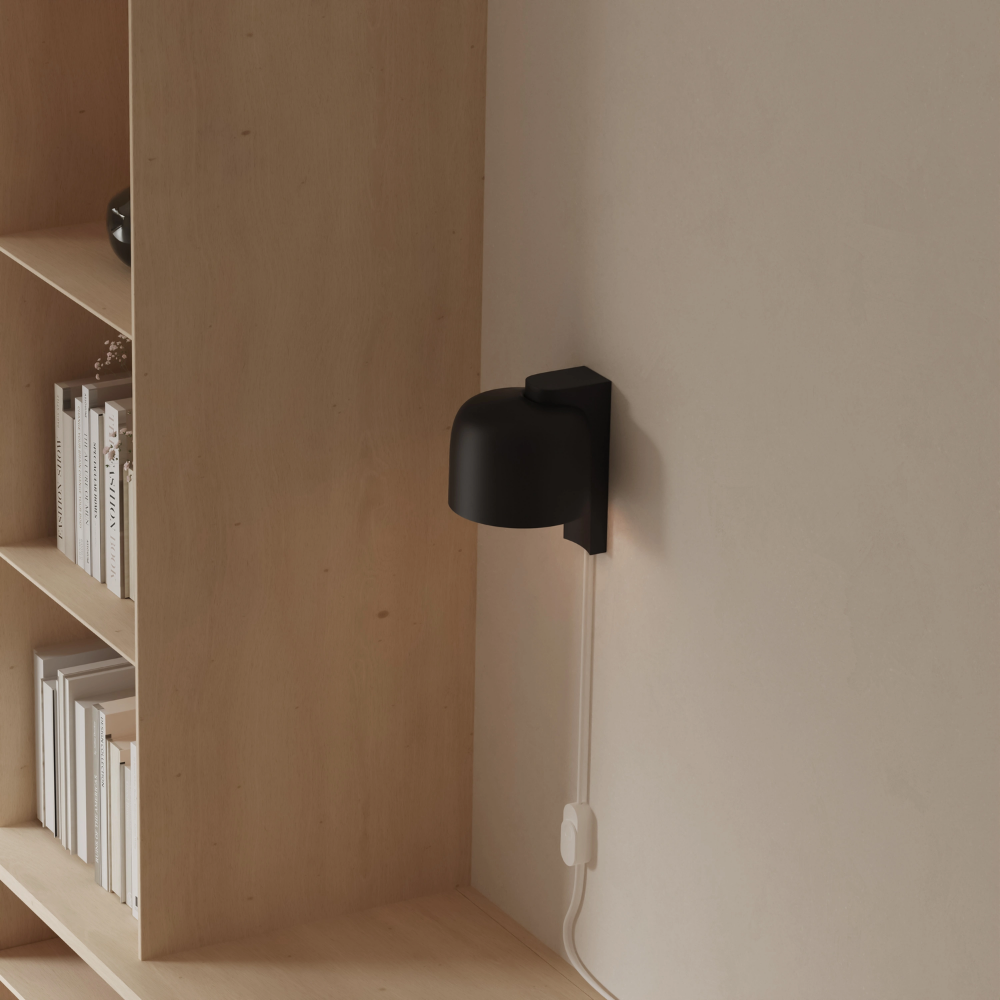 The carbon Gio Wall Light from Gantri in a home office.