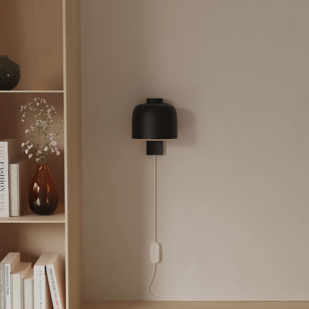 The carbon Gio Wall Light from Gantri in a living room.