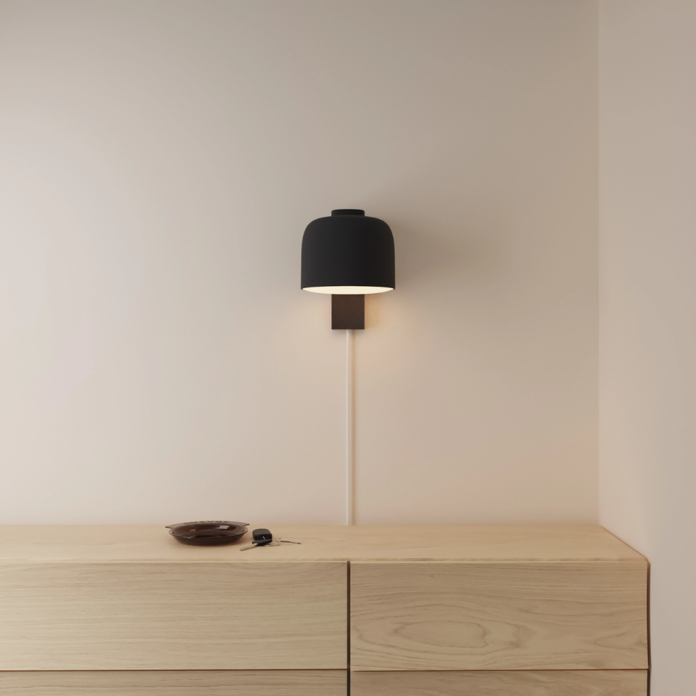 The carbon Gio Wall Light from Gantri in a primary bedroom.