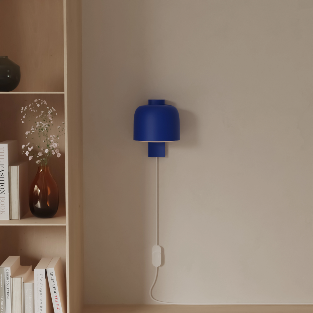 The cobalt Gio Wall Light from Gantri in a living room.