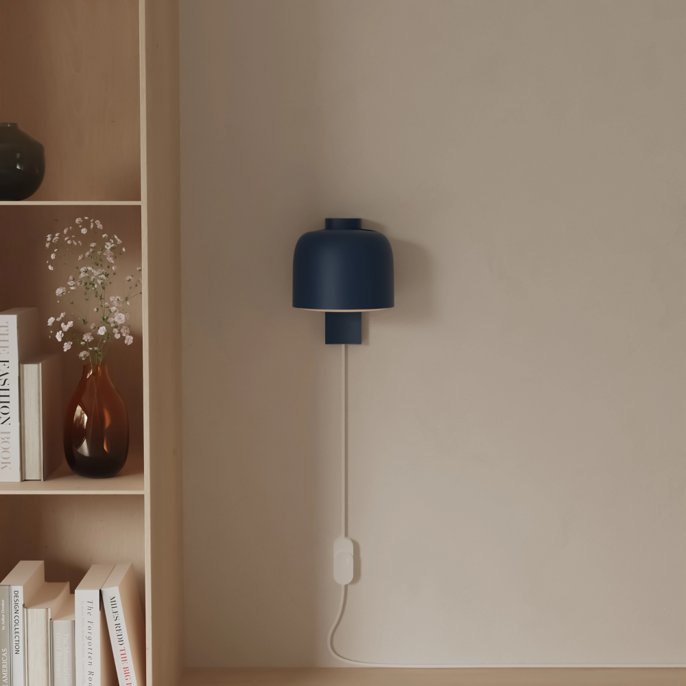 The midnight Gio Wall Light from Gantri in a living room.
