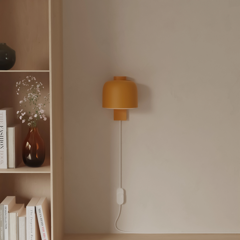 The mustard Gio Wall Light from Gantri in a living room.