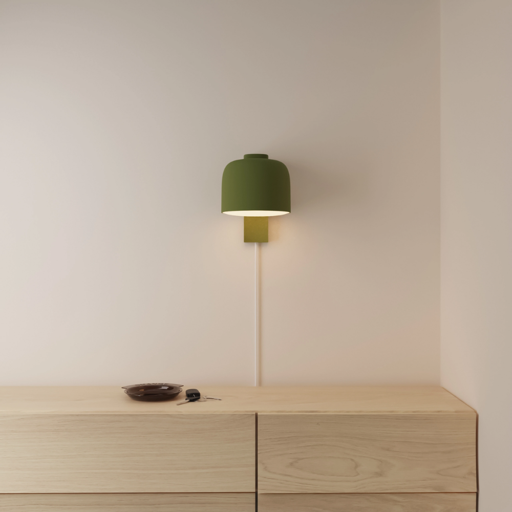 The olive Gio Wall Light from Gantri in a primary bedroom.