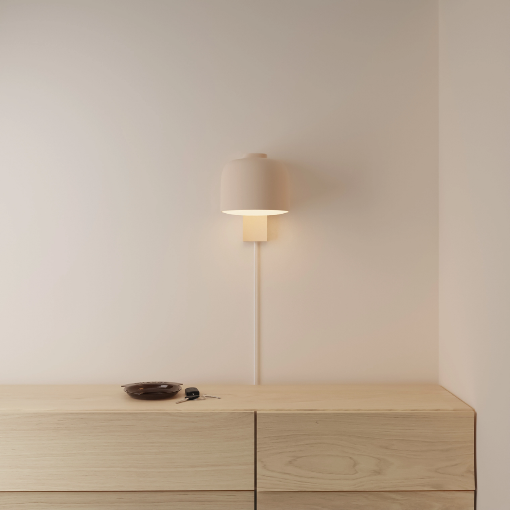 The peach Gio Wall Light from Gantri in a primary bedroom.
