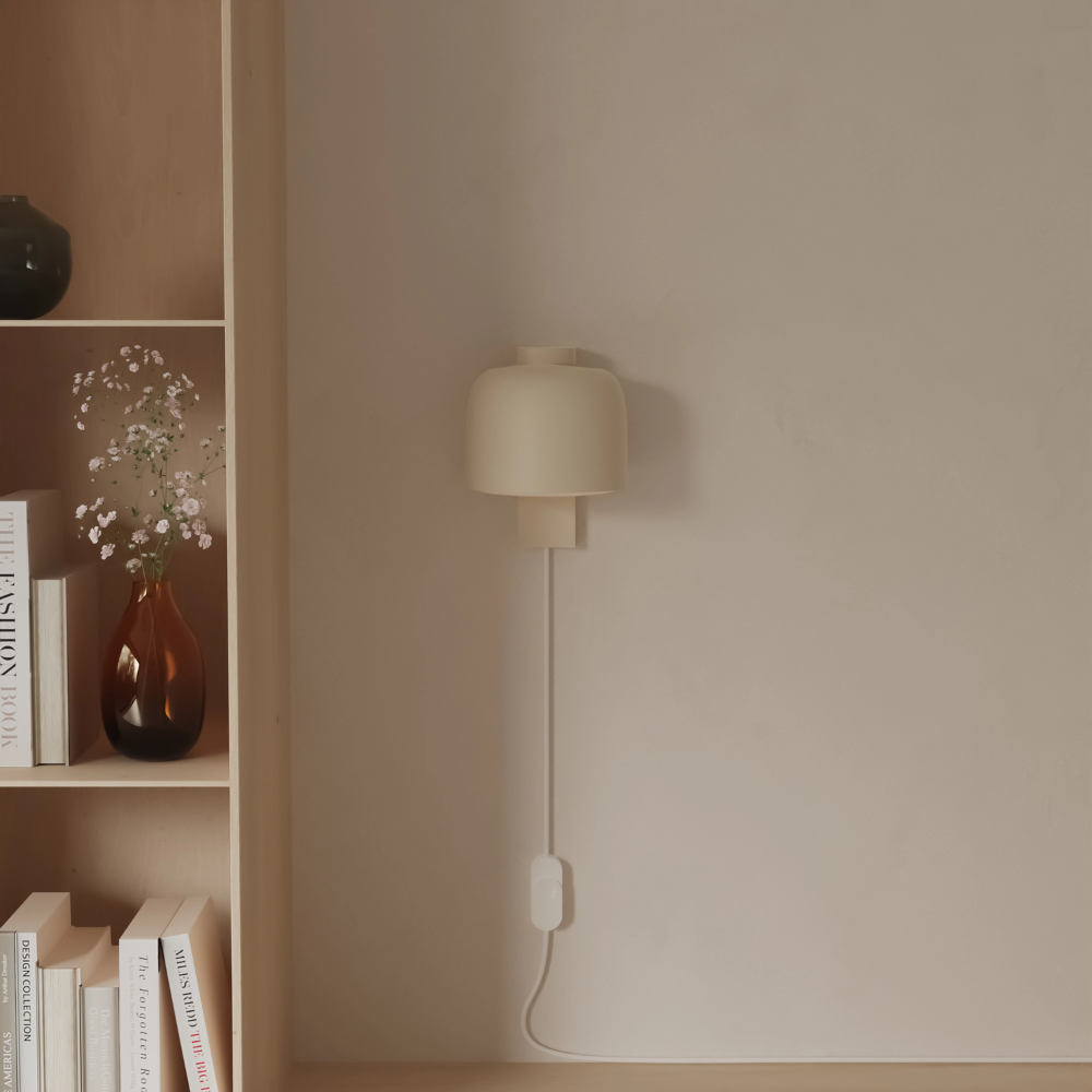 The sand Gio Wall Light from Gantri in a living room.