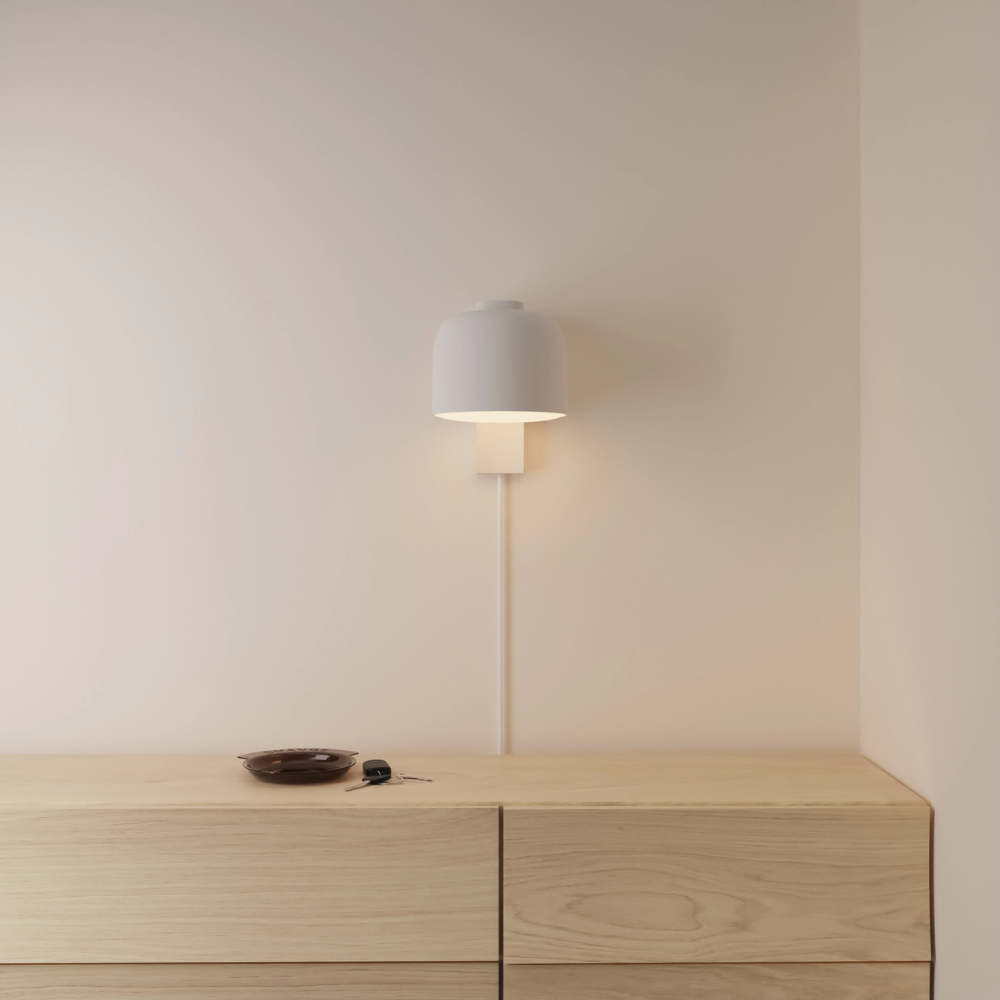 The stone Gio Wall Light from Gantri in a primary bedroom.