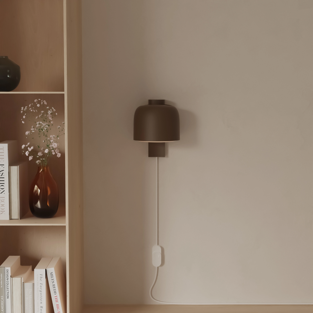 The walnut Gio Wall Light from Gantri in a living room.