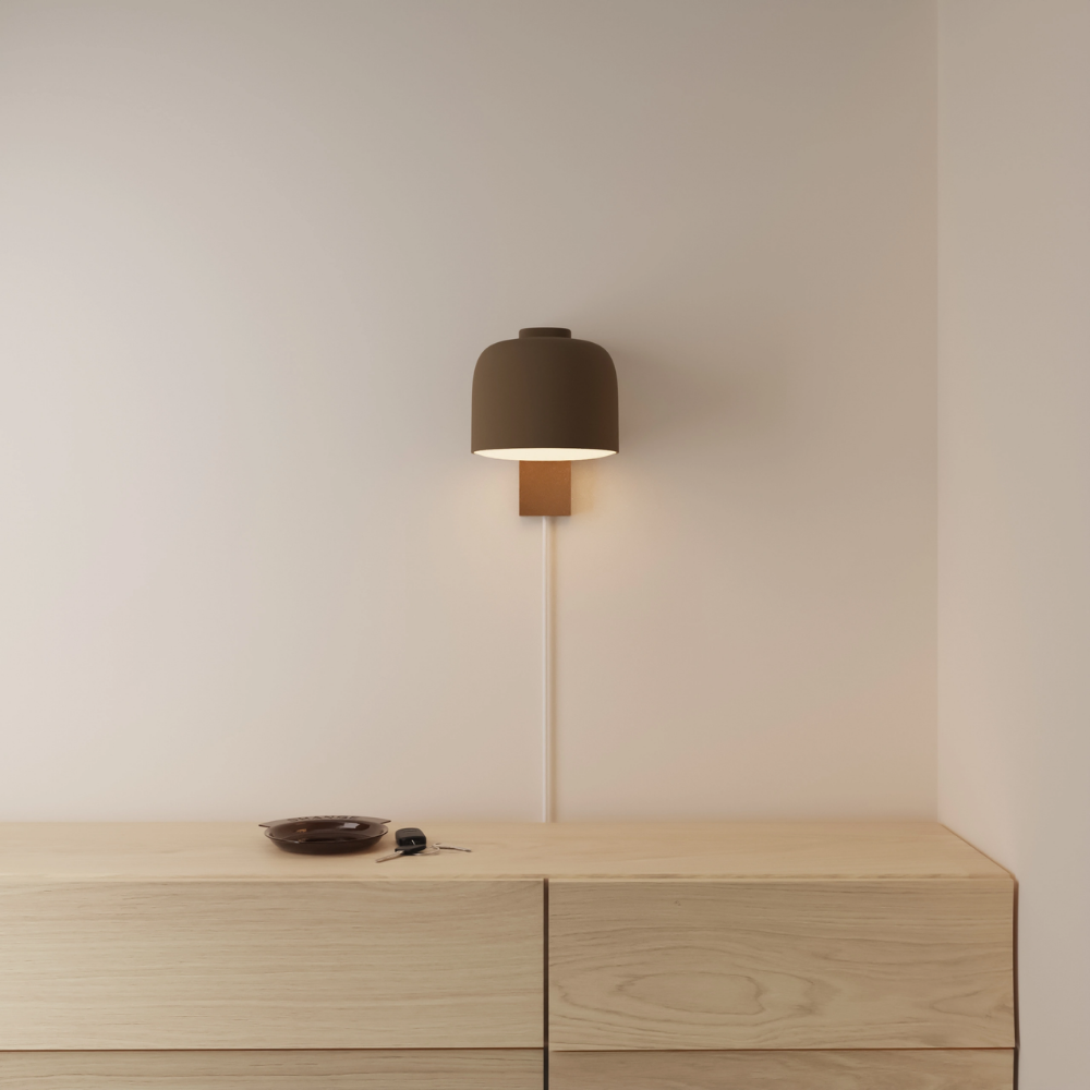 The walnut Gio Wall Light from Gantri in a primary bedroom.