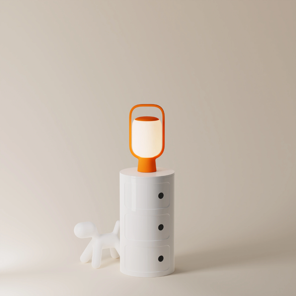 The persimmon Kero Table Light from Gantri in a home office.