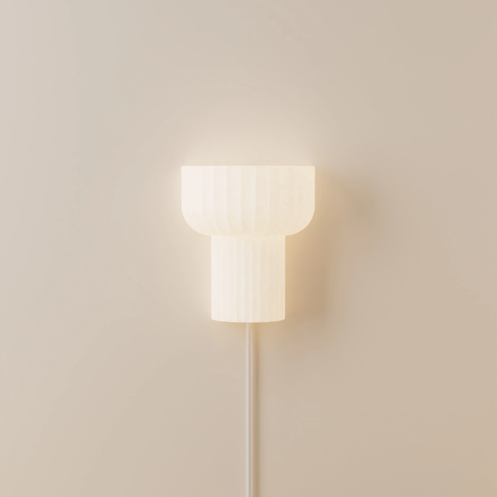 The white Word Wall Light from Gantri in a studio.