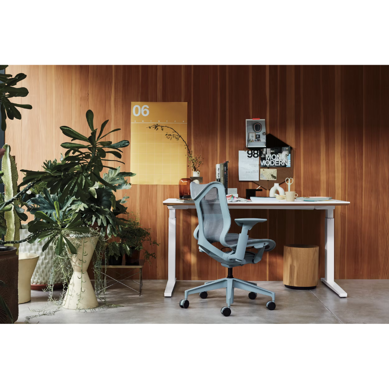 The glacier Cosm Office Chair from Herman Miller in a workspace.