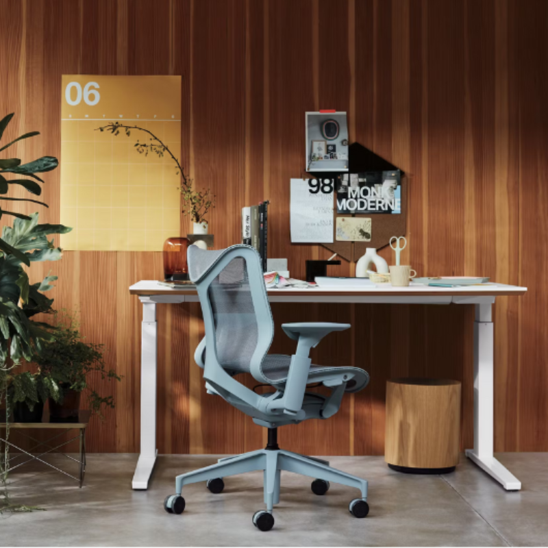 The glacier Cosm Office Chair from Herman Miller in a workspace.