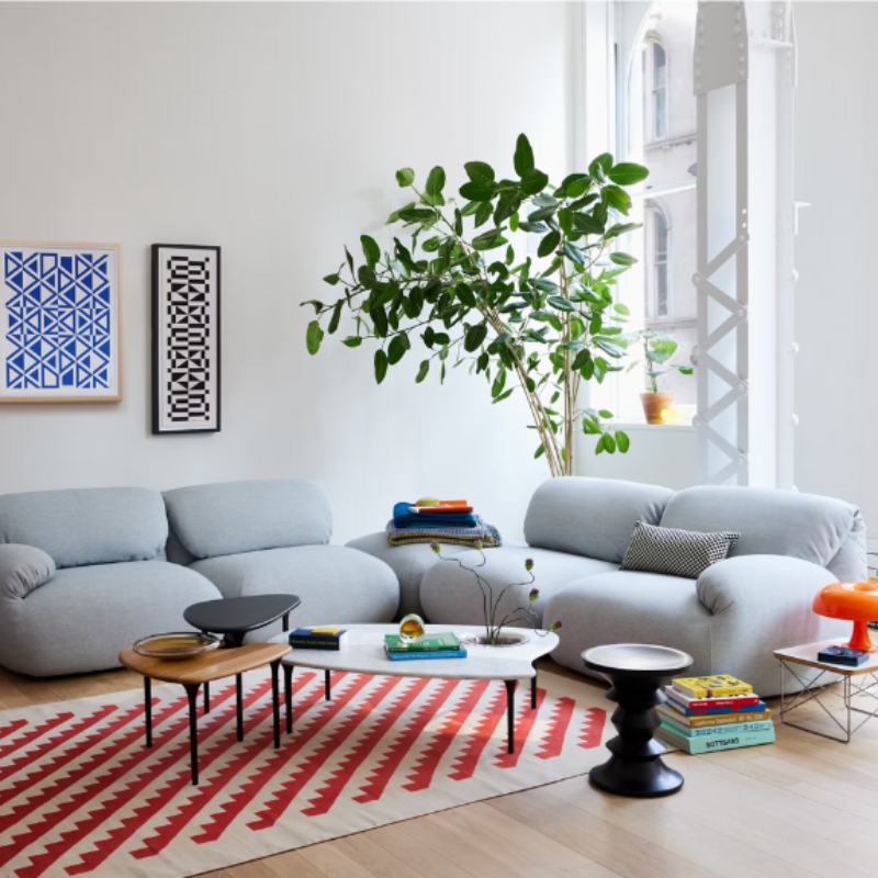 Three of the Cyclade Tables from Herman Miller within a lounge area.