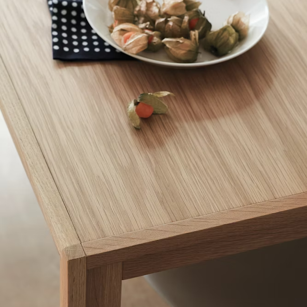 The oak Doubleframe Table from Herman Miller in a close up with decor on the table.