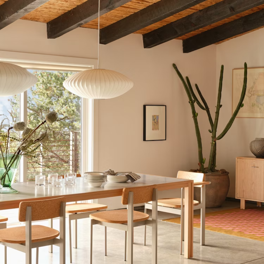 The oak Doubleframe Table from Herman Miller in a dining area.