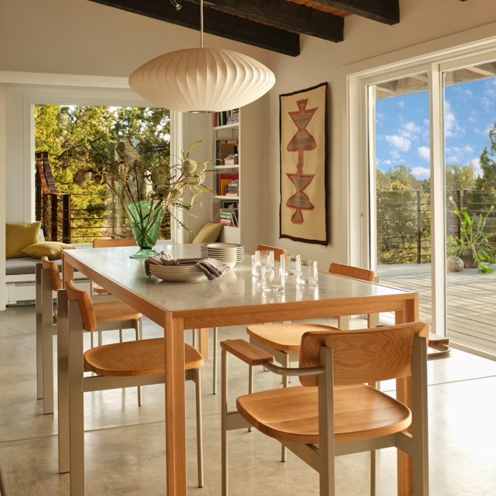 The oak Doubleframe Table from Herman Miller in a family area.