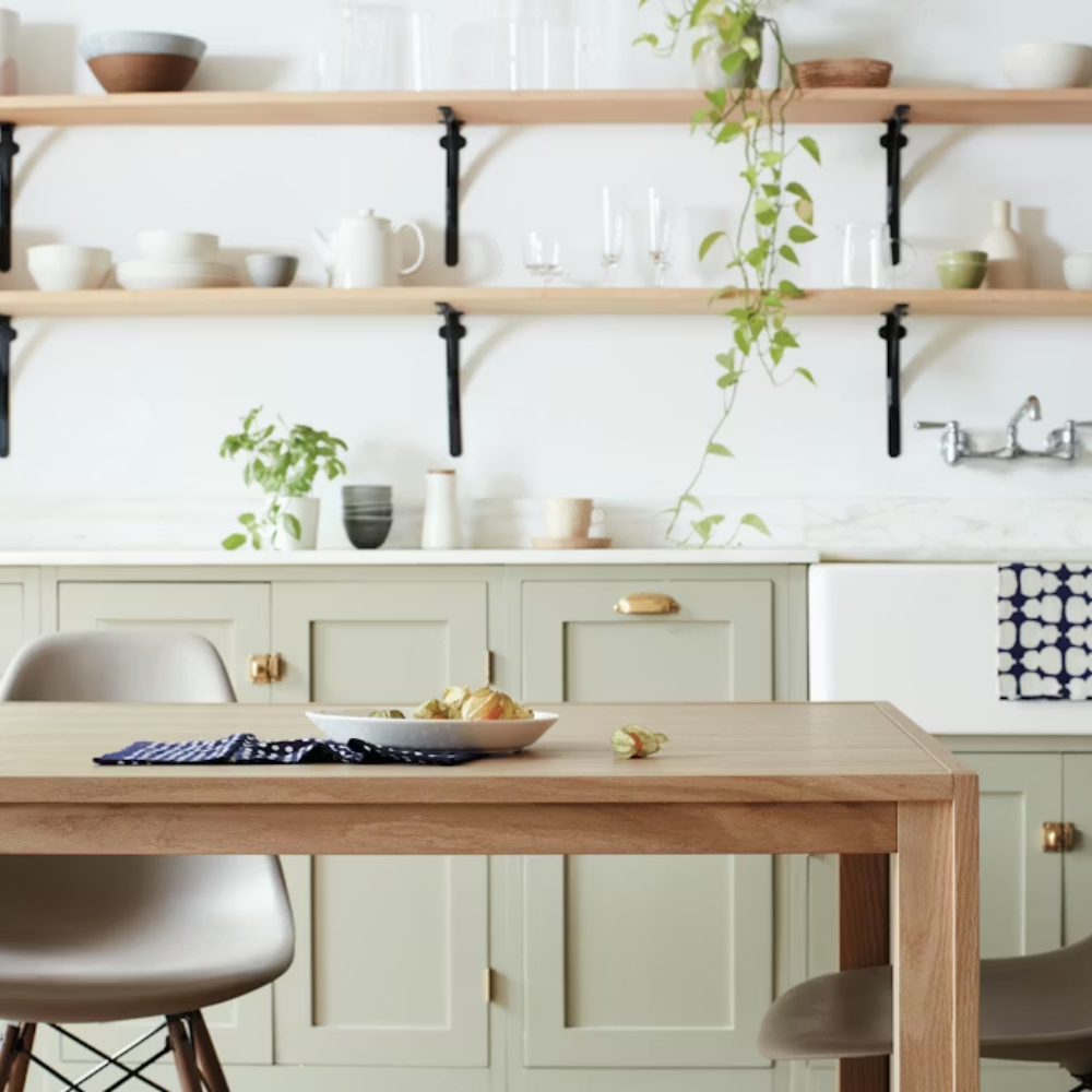 The oak Doubleframe Table from Herman Miller in a spacious dining room.