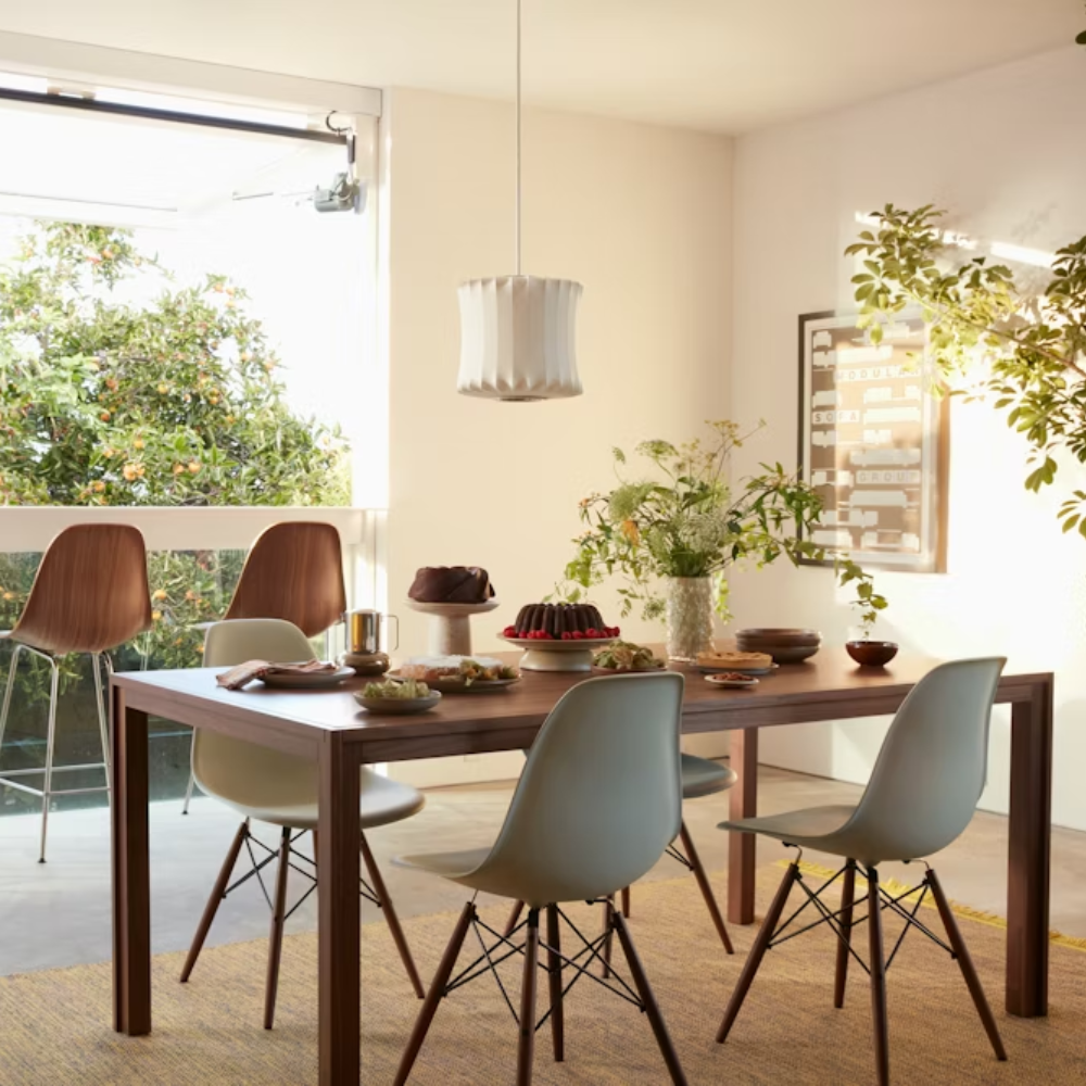 The walnut Doubleframe Table from Herman Miller in a living room.