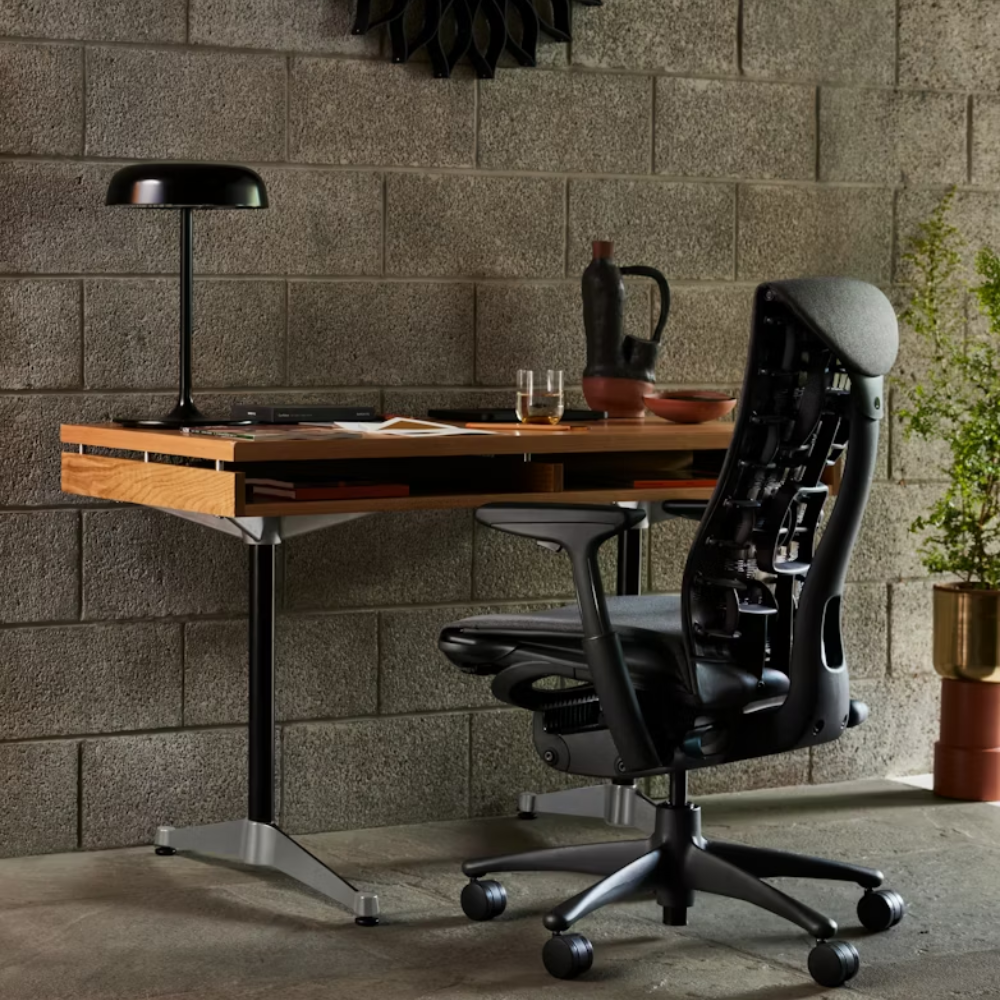 The white oak Eames 2500 Series Executive Desk from Herman Miller in a home office.