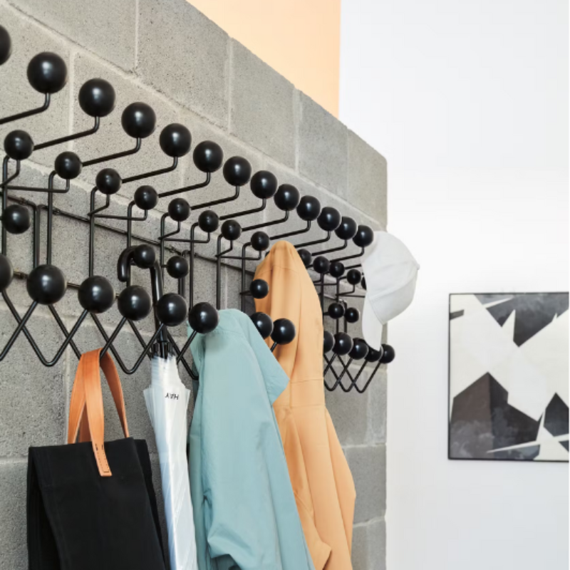 The Eames Hang-It-All from Herman Miller in a linear row, showing the multiple uses of the rack.