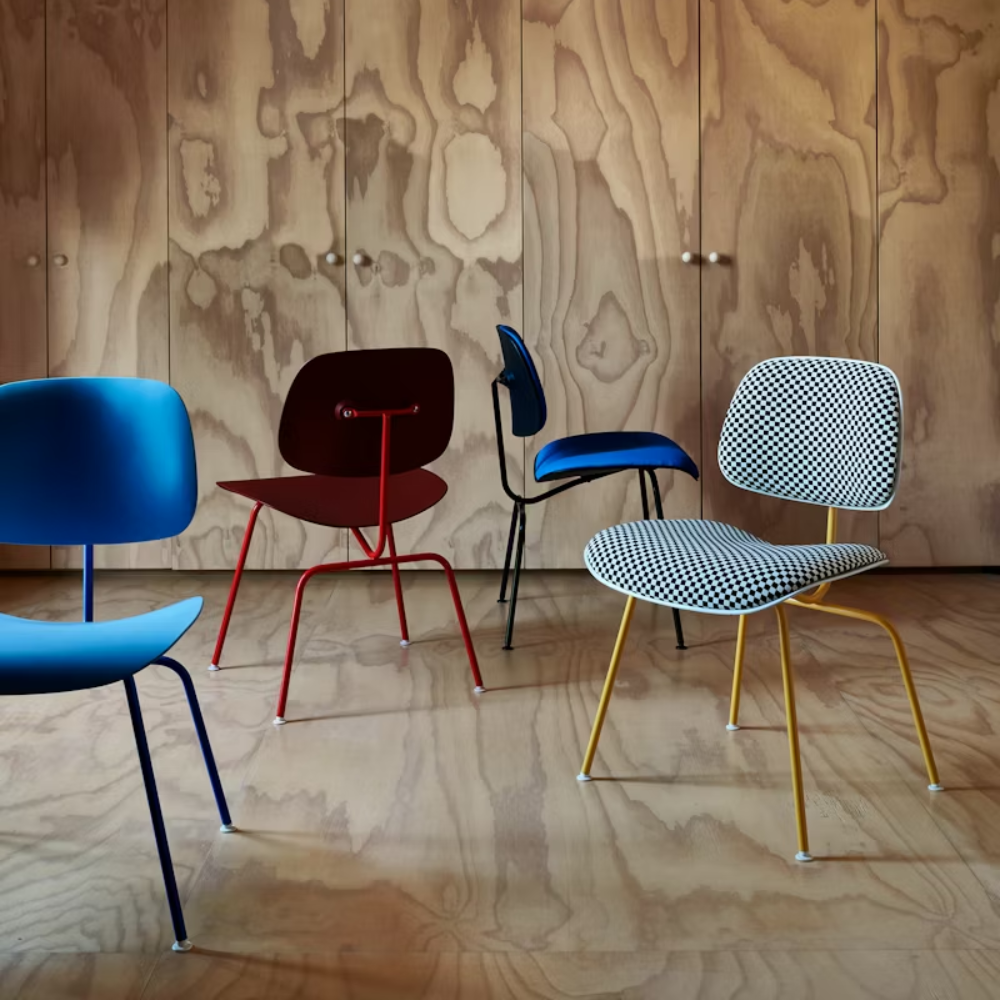 The Eames Molded Plastic Dining Chair from Herman Miller in a living room with various options. all-groups