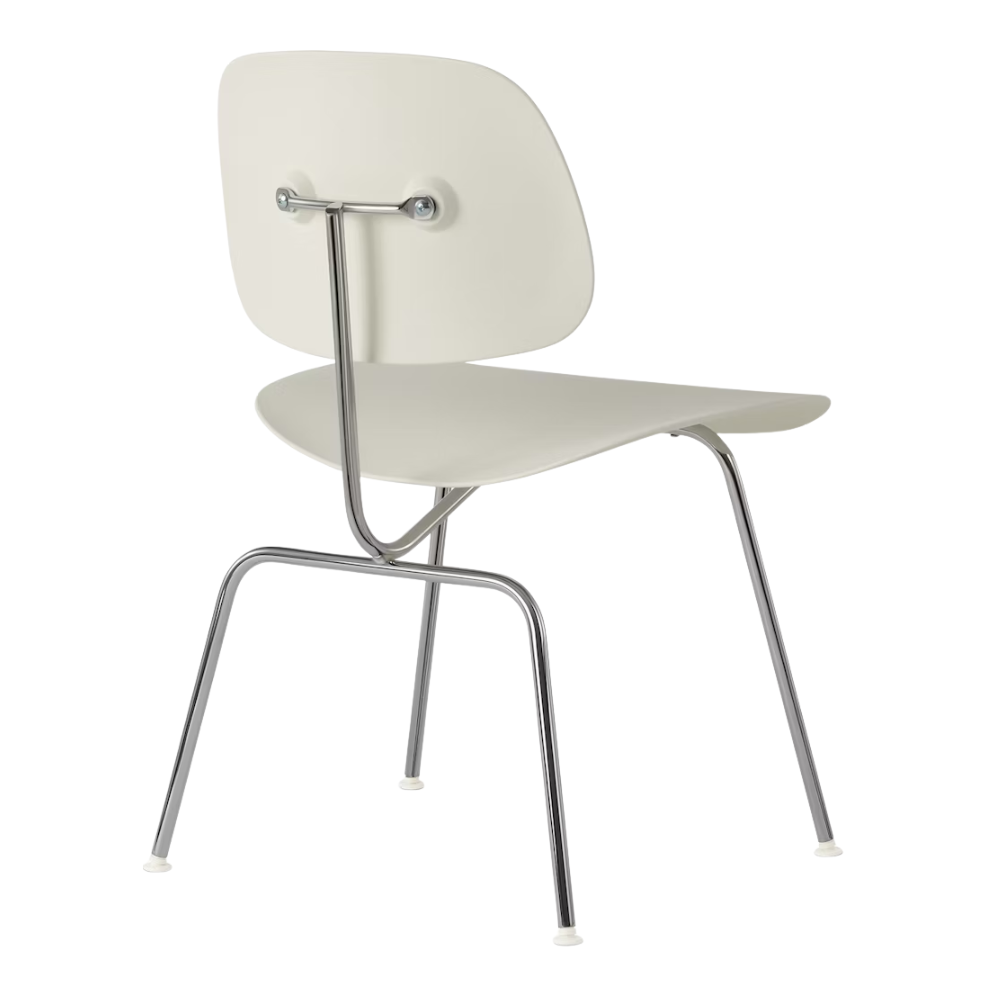 The Eames Molded Plastic Dining Chair from Herman Miller with the white shell and trivalent chrome leg finish from the back at an angle.