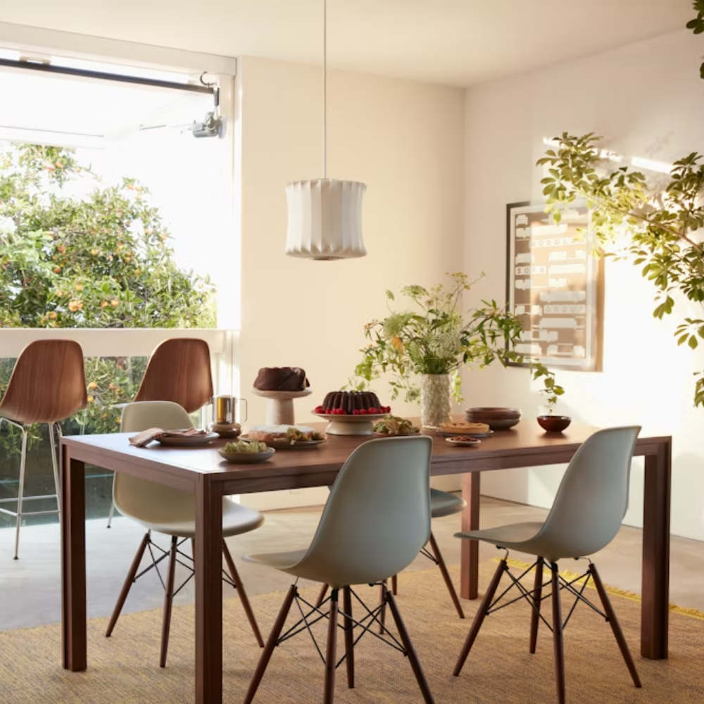 The white shell Eames Molded Plastic Side Chair Dowel-Leg Base from Herman Miller in a dining room.
