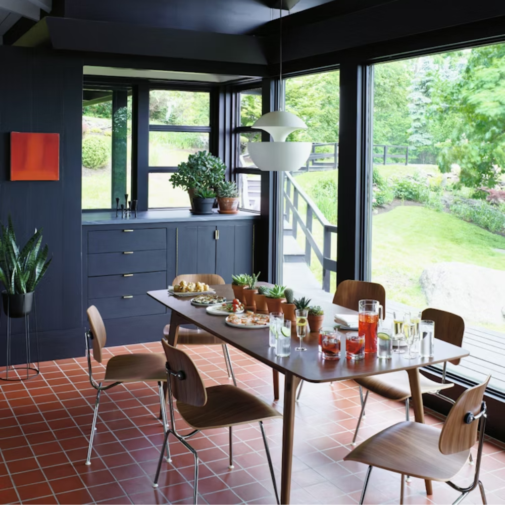 The Eames Molded Plywood Dining Chair Metal Base from Herman Miller in a dining room. all-groups