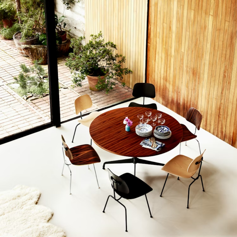 The Eames Molded Plywood Dining Chair Metal Base from Herman Miller in a living room. all-groups