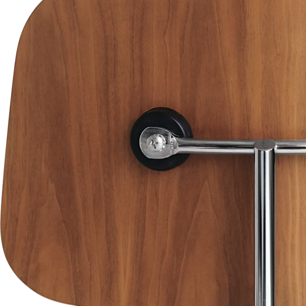 The Eames Molded Plywood Dining Chair Metal Base from Herman Miller with the santos palisander shell and trivalent chrome legs showing the back in detail.
