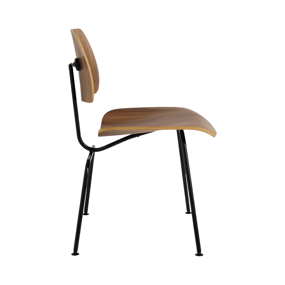 The side of the Eames Molded Plywood Dining Chair Metal Base from Herman Miller with the walnut shell and black legs.