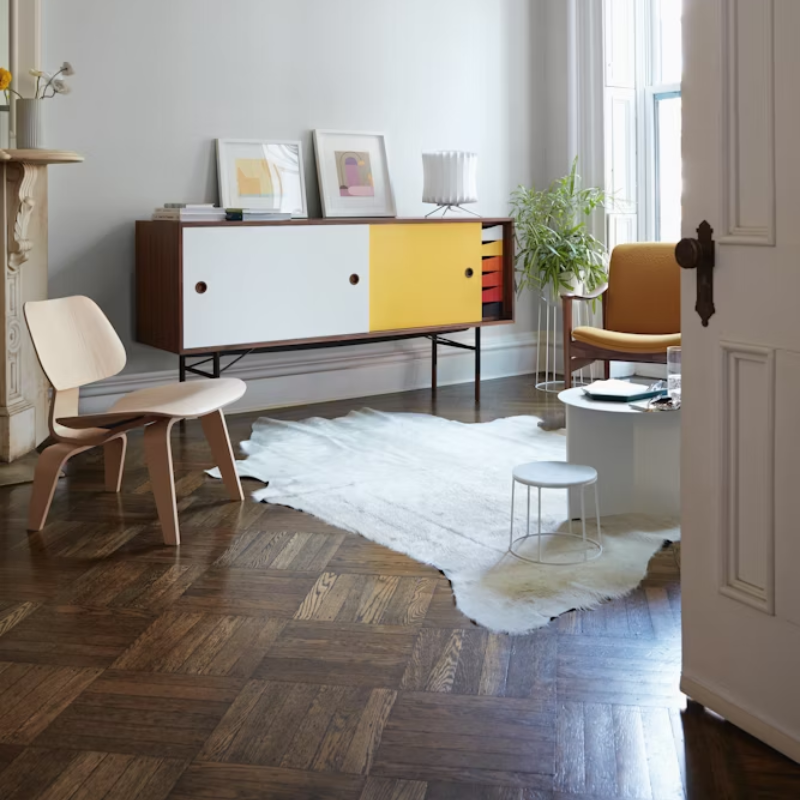 The White Ash Eames Molded Plywood Lounge Chair Wood Base from Herman Miller in a study space.