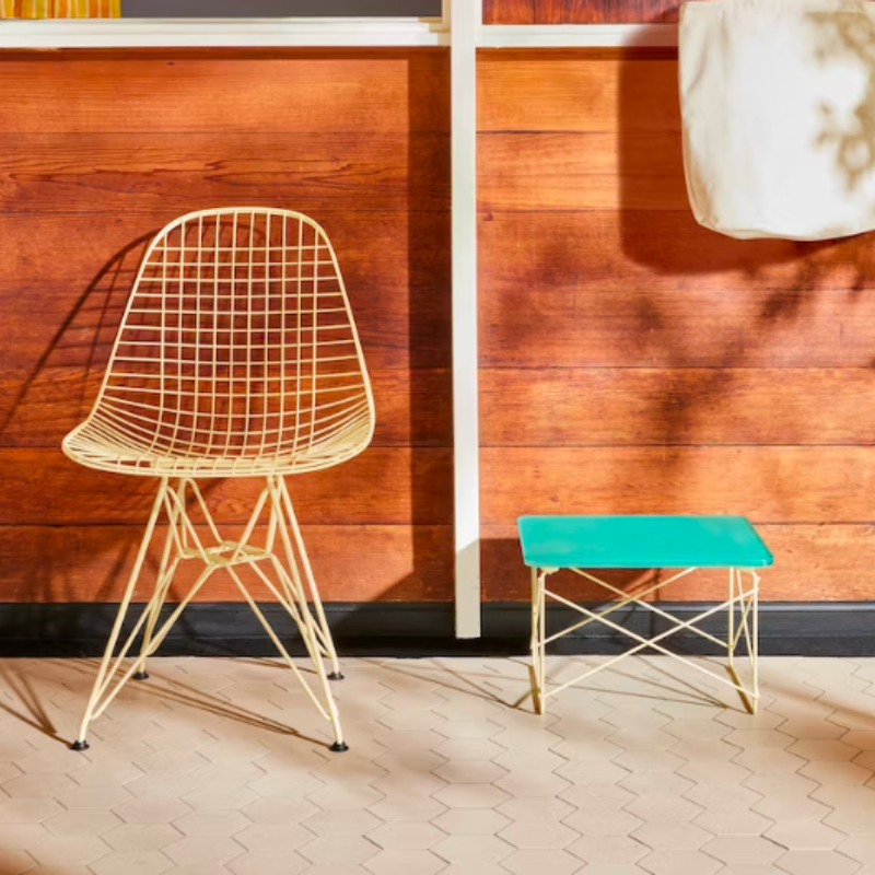 The mint green and powder yellow Eames Wire Base Low Table, Herman Miller x HAY from Herman Miller in a living room.