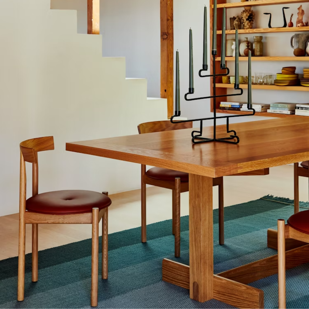 The white oak Land Dining Table from Herman Miller in a dining room.