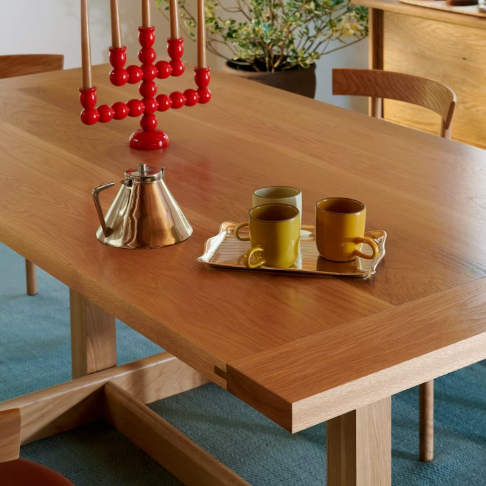 The white oak Land Dining Table from Herman Miller in a living room.