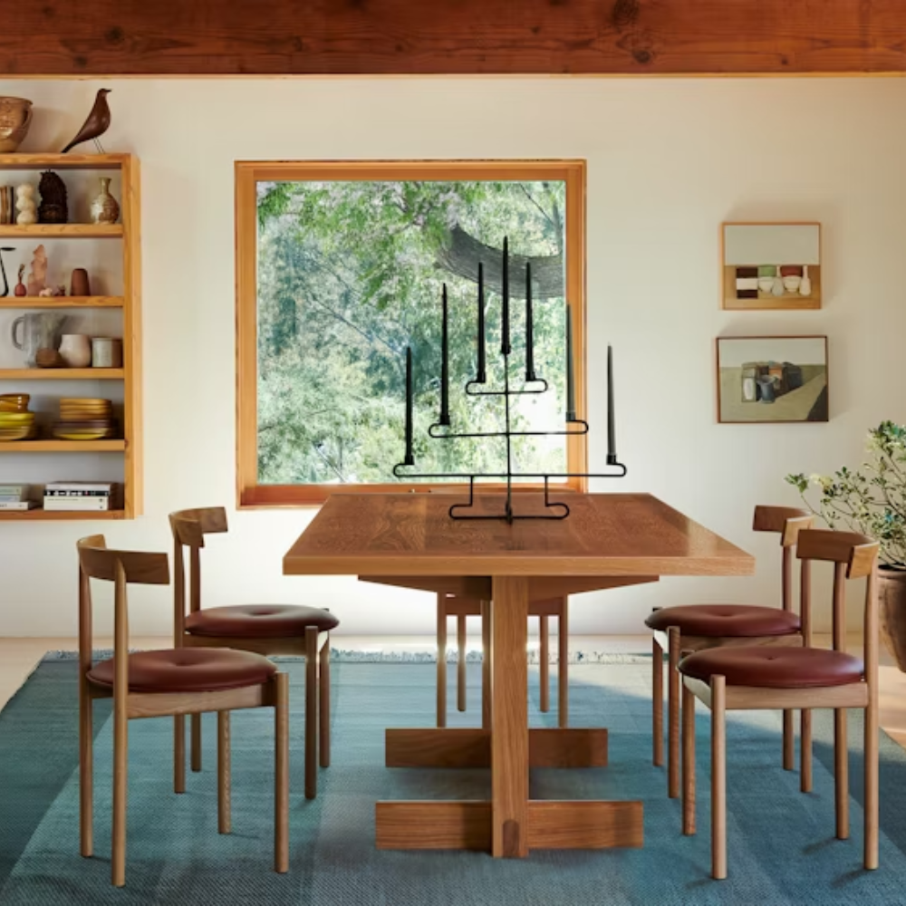 The white oak Land Dining Table from Herman Miller in a living space.