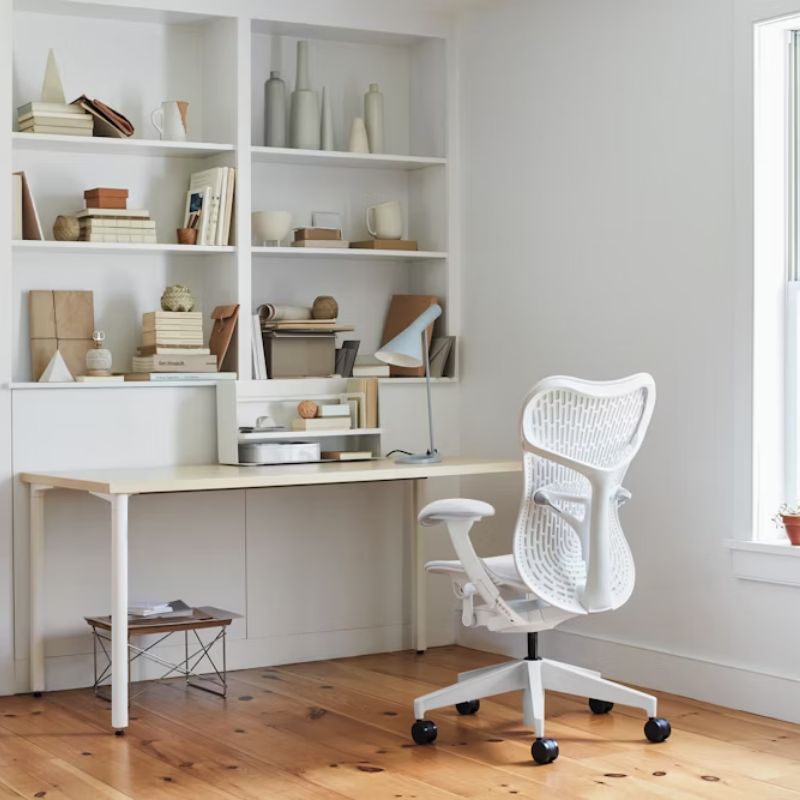The Mirra 2 Chair from Herman Miller with the butterfly suspension back and alpine frame in alpine color in an office.