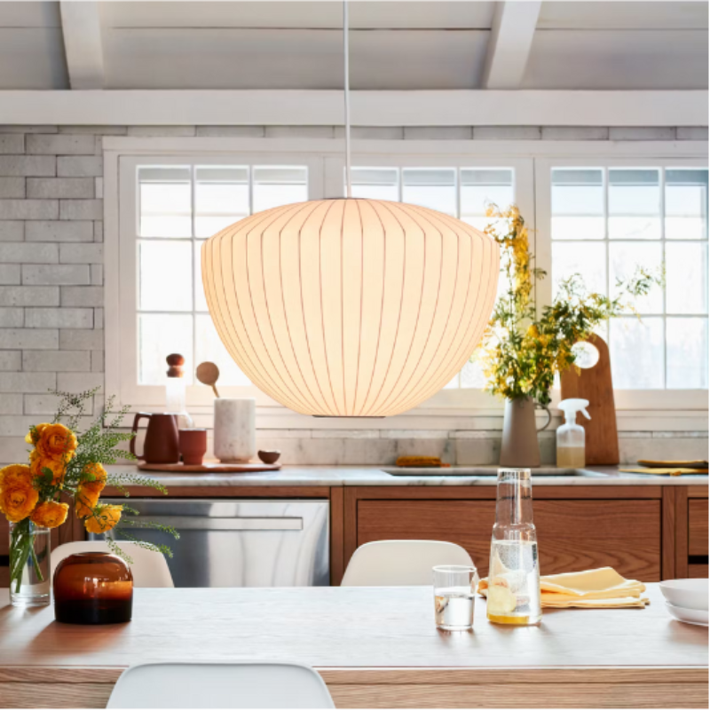 The Nelson Apple Bubble Pendant from Herman Miller above a dining table.