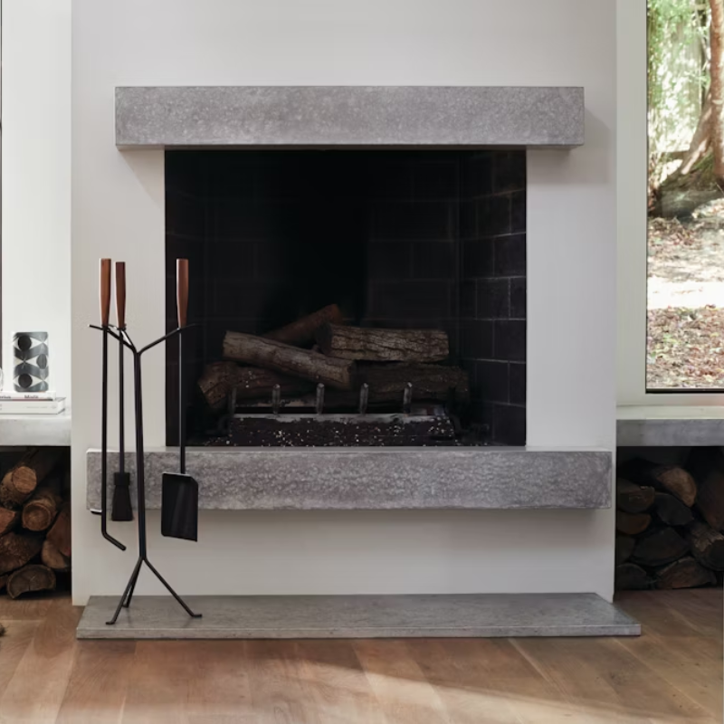 The Nelson Fireplace Tool Set from Herman Miller in a lounge.