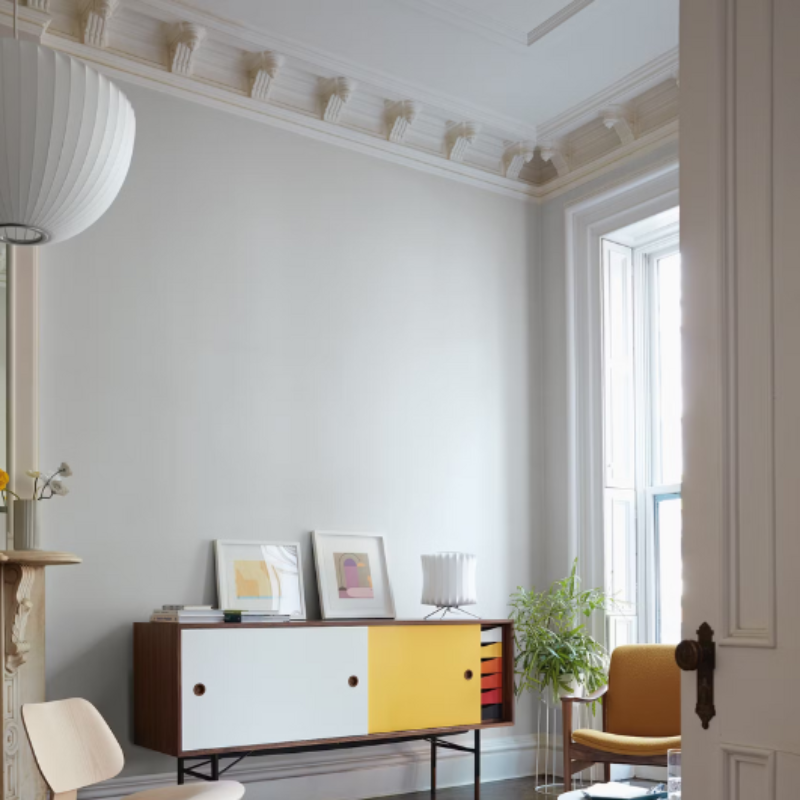 The Nelson Lantern Tripod Table Lamp from Herman Miller in a living room lifestyle photograph.