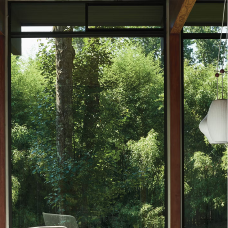 The Nelson Triple Bubble Pendant Fixture from Herman Miller in a lifestyle photograph in a living room. Please note that pendants and cords are not included.