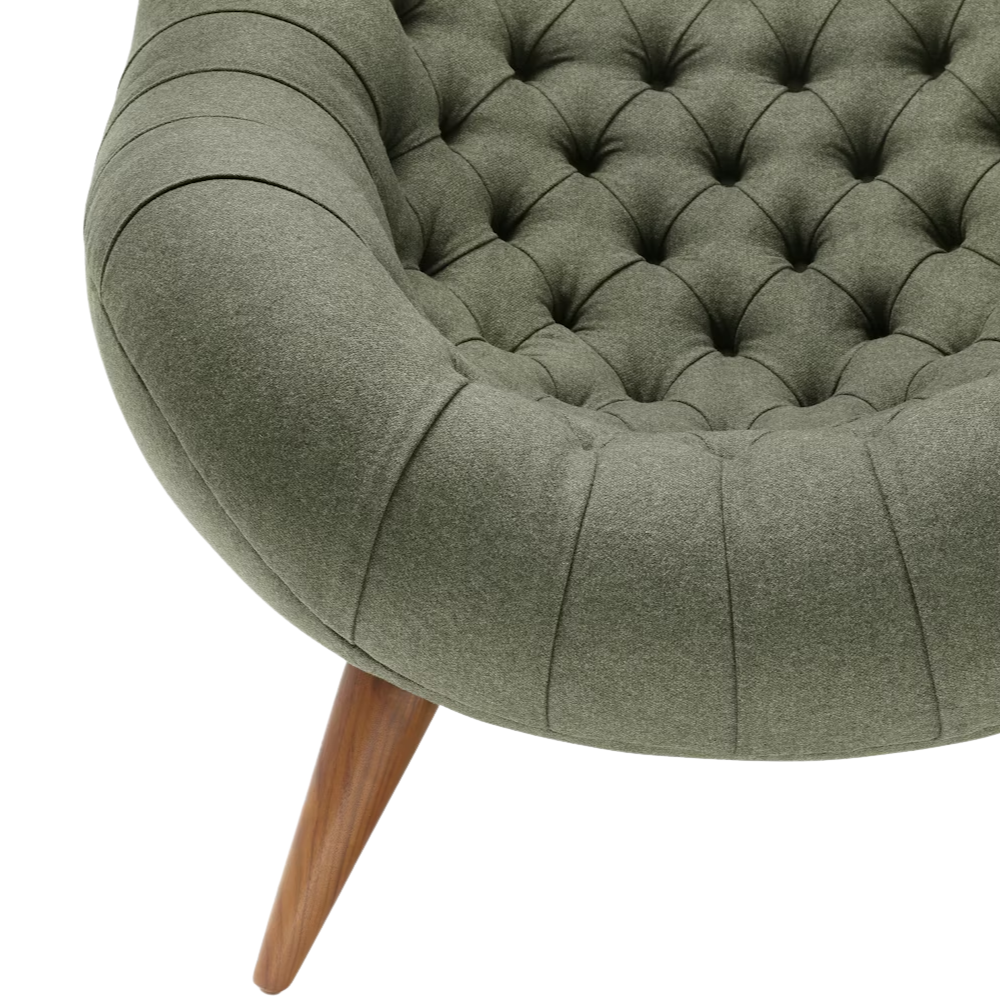 The Rohde Easy Chair from Herman Miller with the agrarian luce upholstery and walnut leg finish showing the base close up.