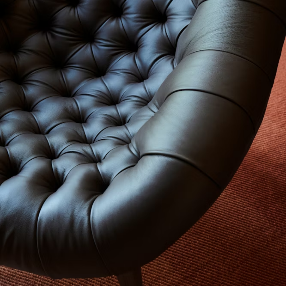 The Rohde Easy Chair from Herman Miller with the obsidian prone leather upholstery in a lounge space.