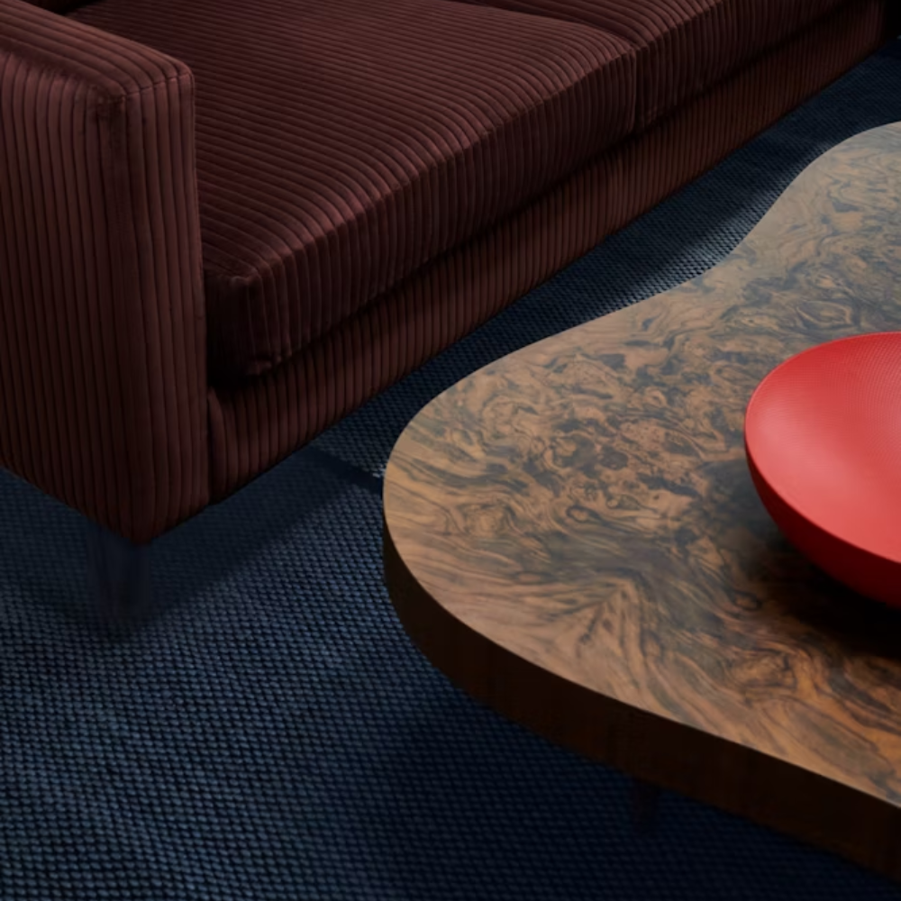 The walnut burl Rohde Paldao Coffee Table from Herman Miller in a living room.