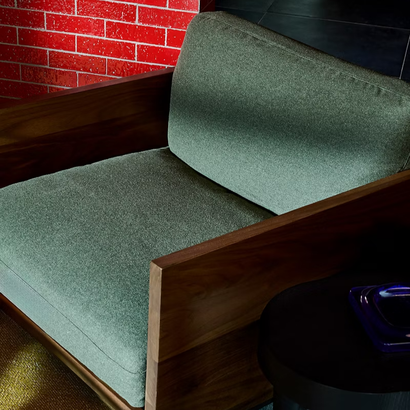 The Tudor Walnut Pawson Drift Lounge Chair from Herman Miller with beck woodlet upholstery in a living room. all-groups