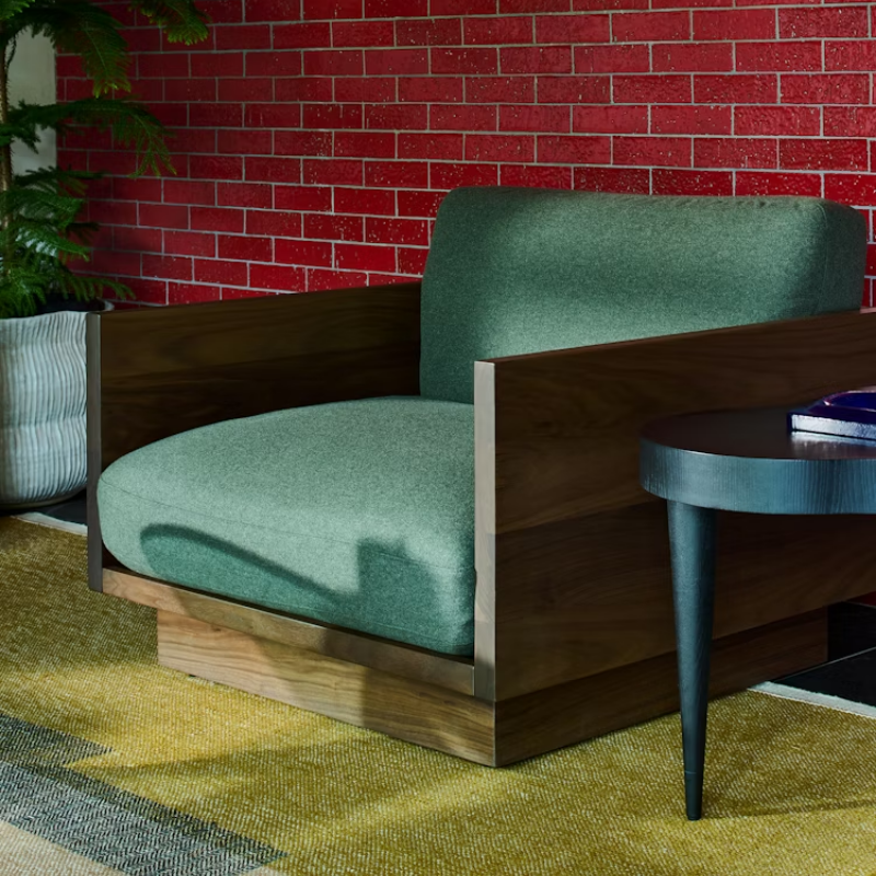 The Tudor Walnut Pawson Drift Lounge Chair from Herman Miller with beck woodlet upholstery in a lounge. all-groups