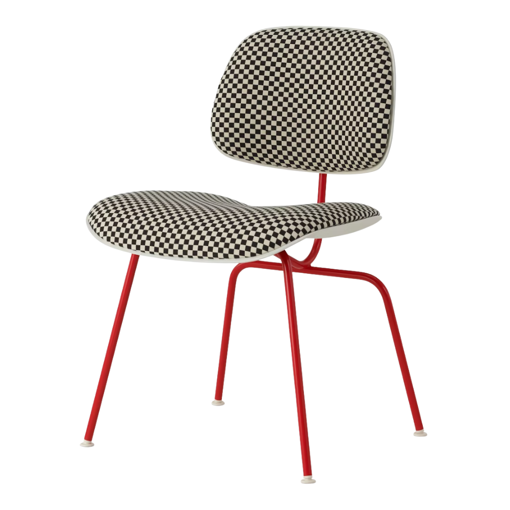 The Upholstered Eames Molded Plastic Dining Chair from Herman Miller with black and white checker upholstery, white shell and blaze leg finish.
